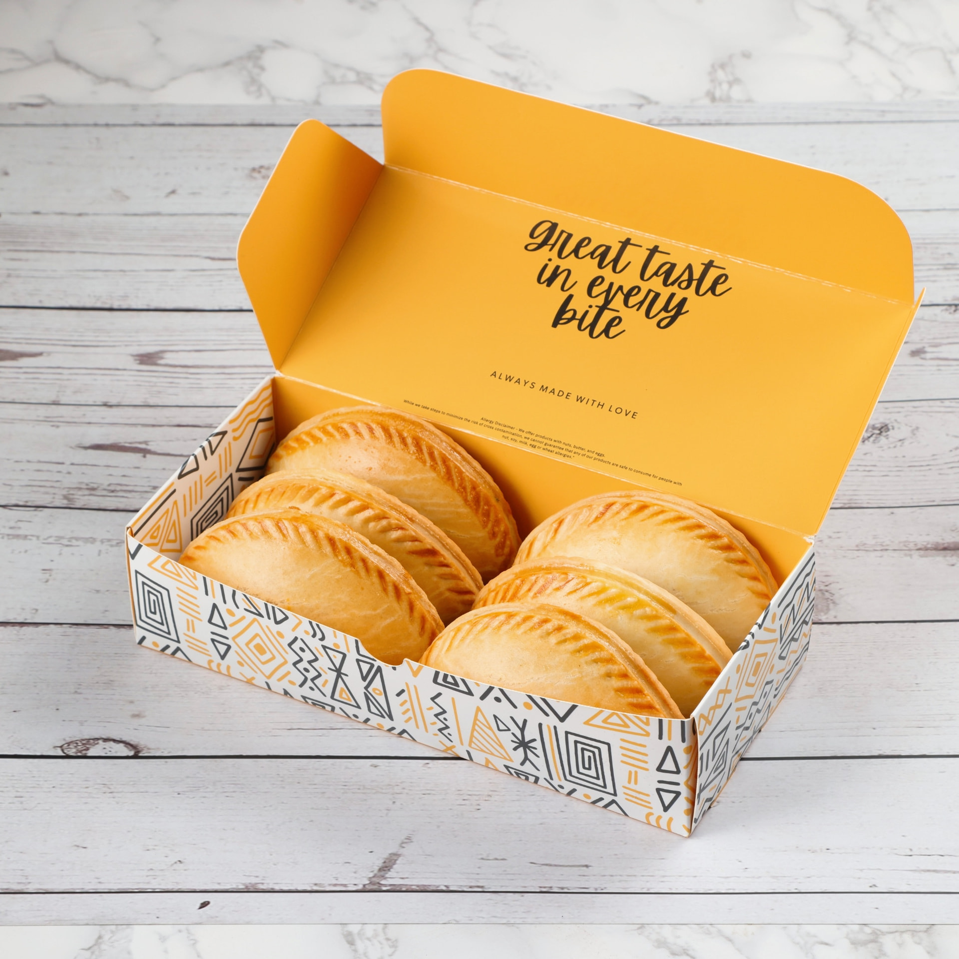 SimplyChops meat pies presented in signature yellow packaging